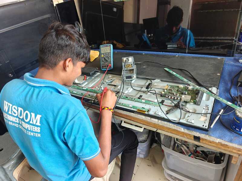 Expert TV repair technician fixing LED TV